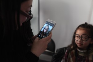 Girl takes pictures with glasses she made