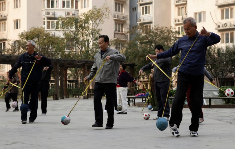 Retired elderlys practice "Cola Ball" with music, an inventive community activity in central Beijing